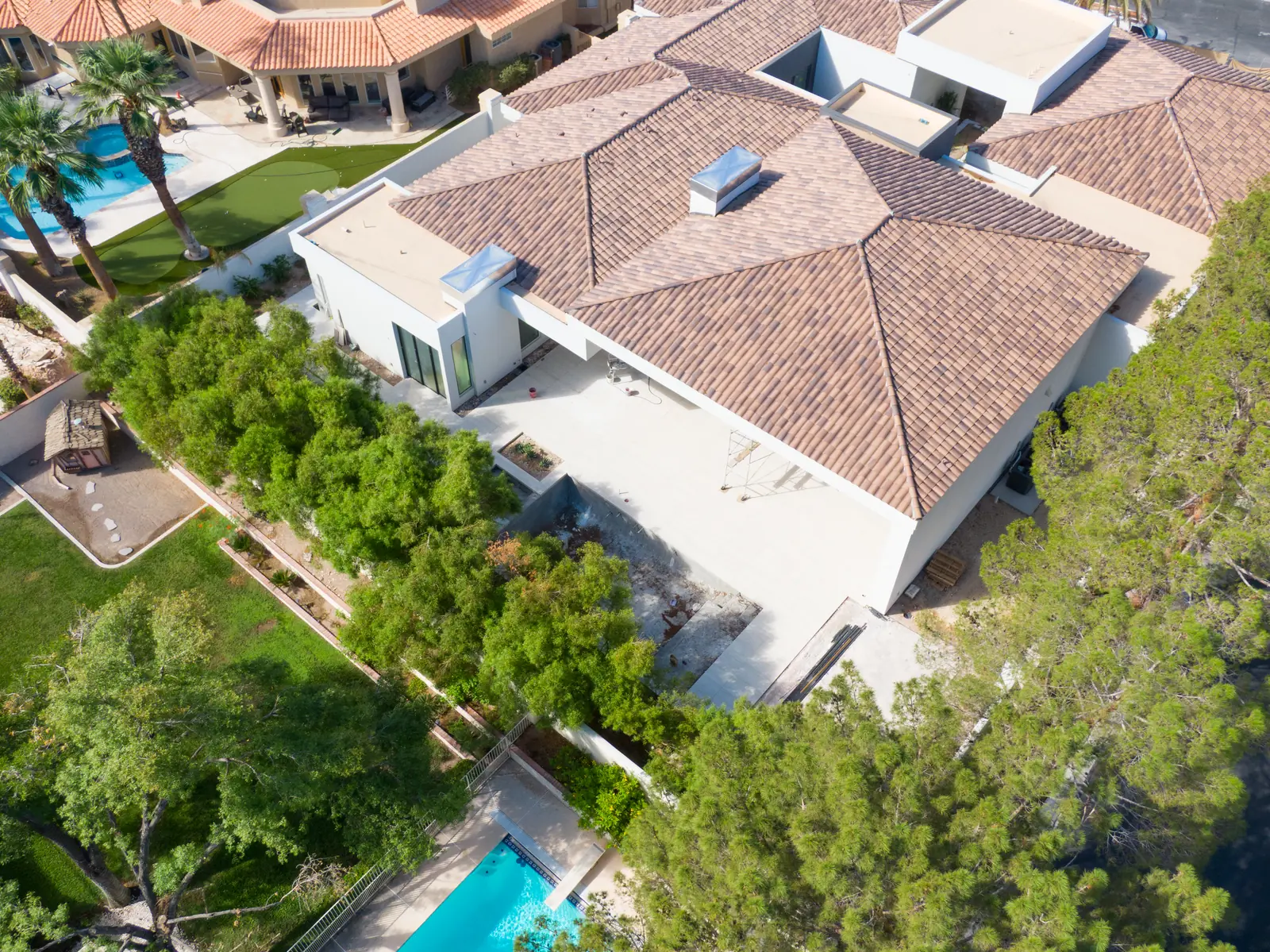 Aerial photograph of the covered patio with scaffolding under it and the unfinished pool shell beside it