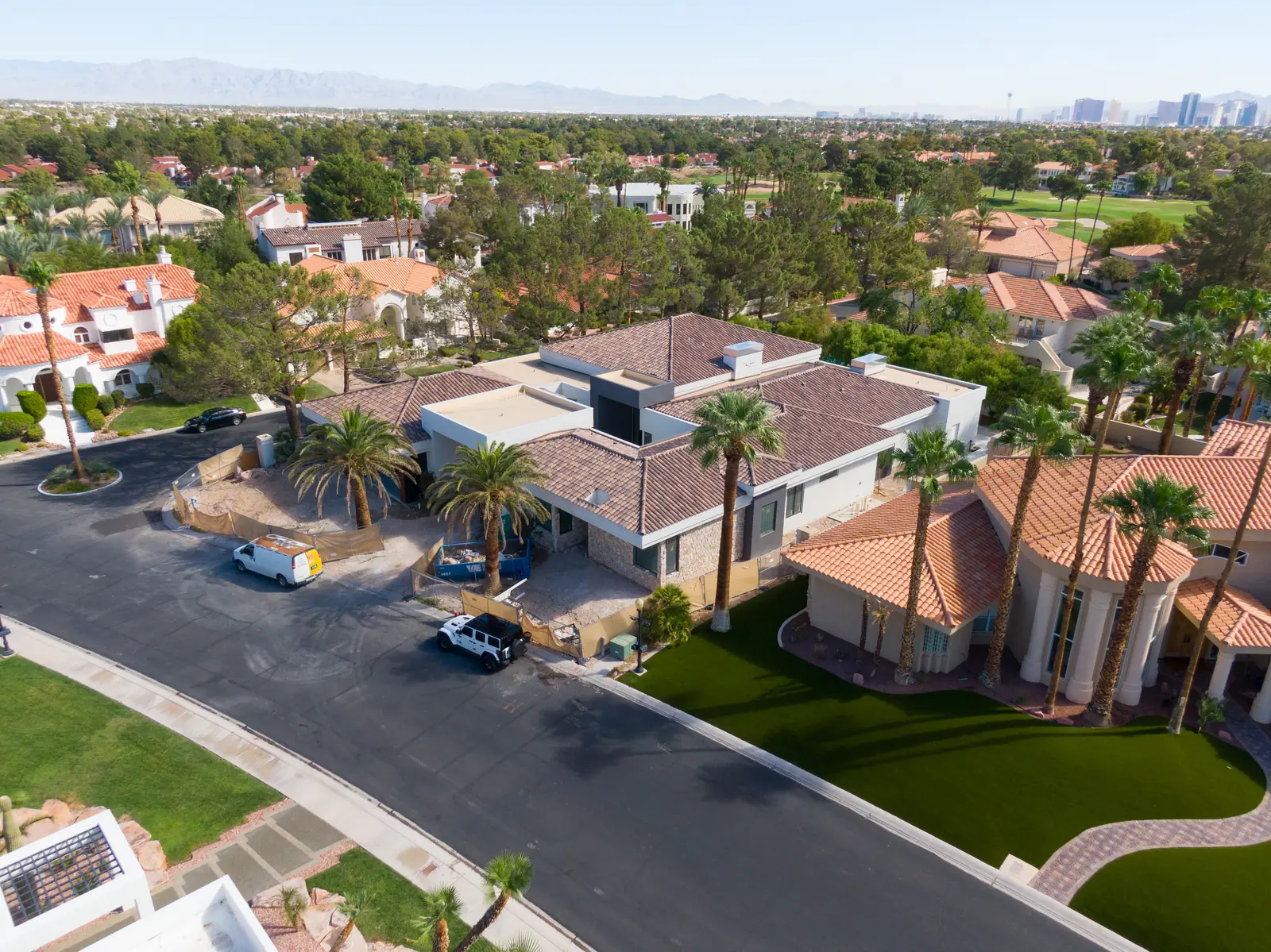Aerial photograph of the front of the house under construction with the valley and mountains in the distance
