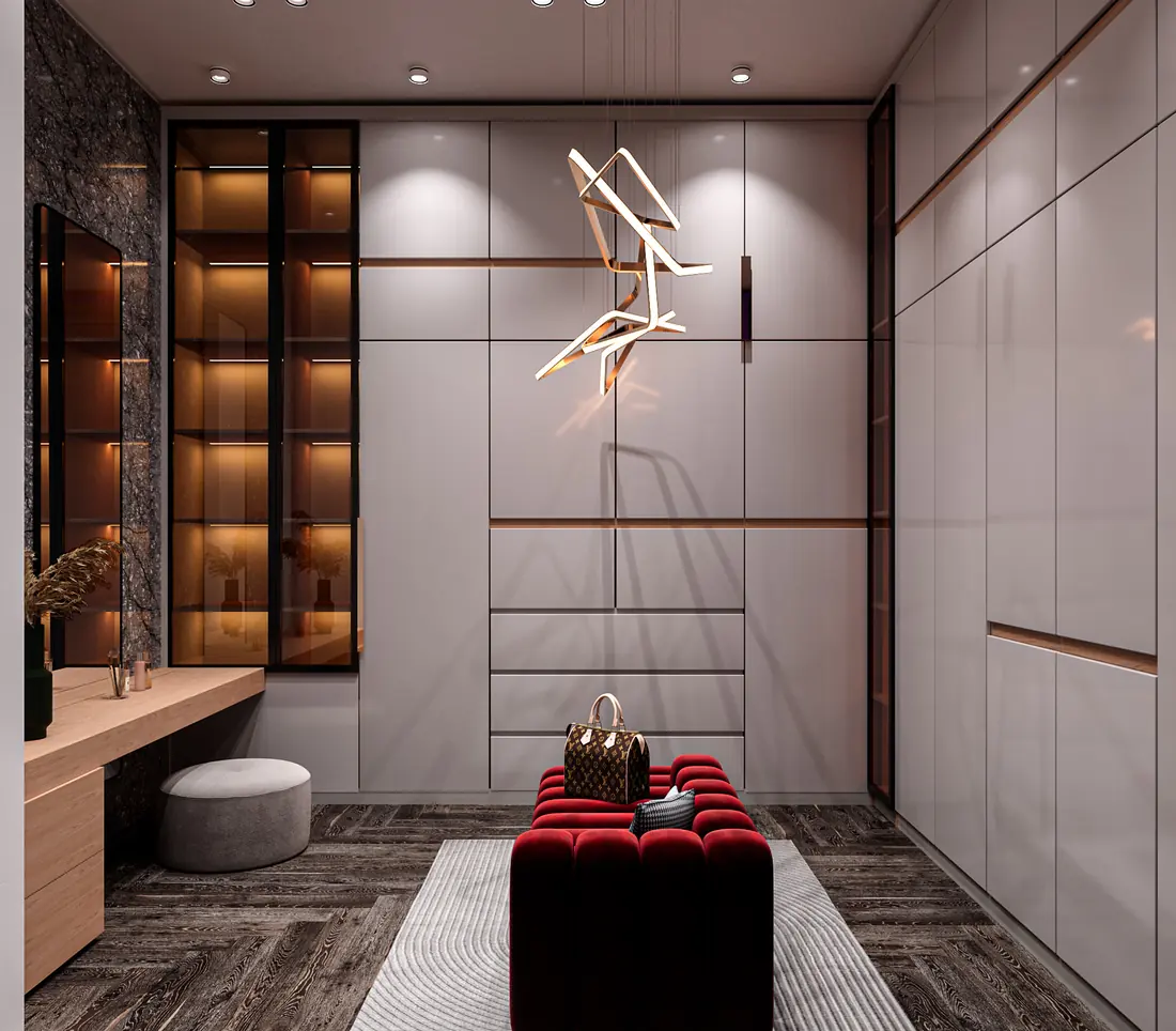 Her walk in closet with lit display cabinetry, an island bench and a dressing vanity