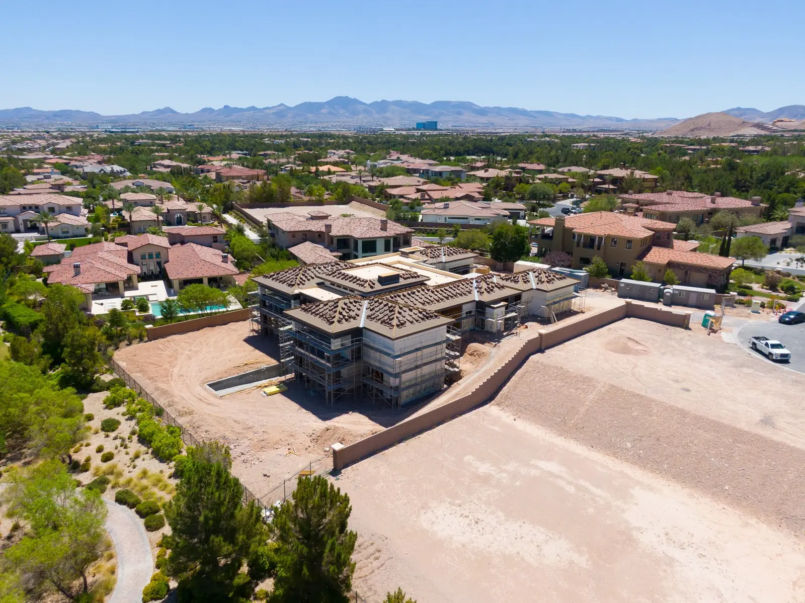 Aerial showing the open graded pad and the rear boundary wall with the valley beyond