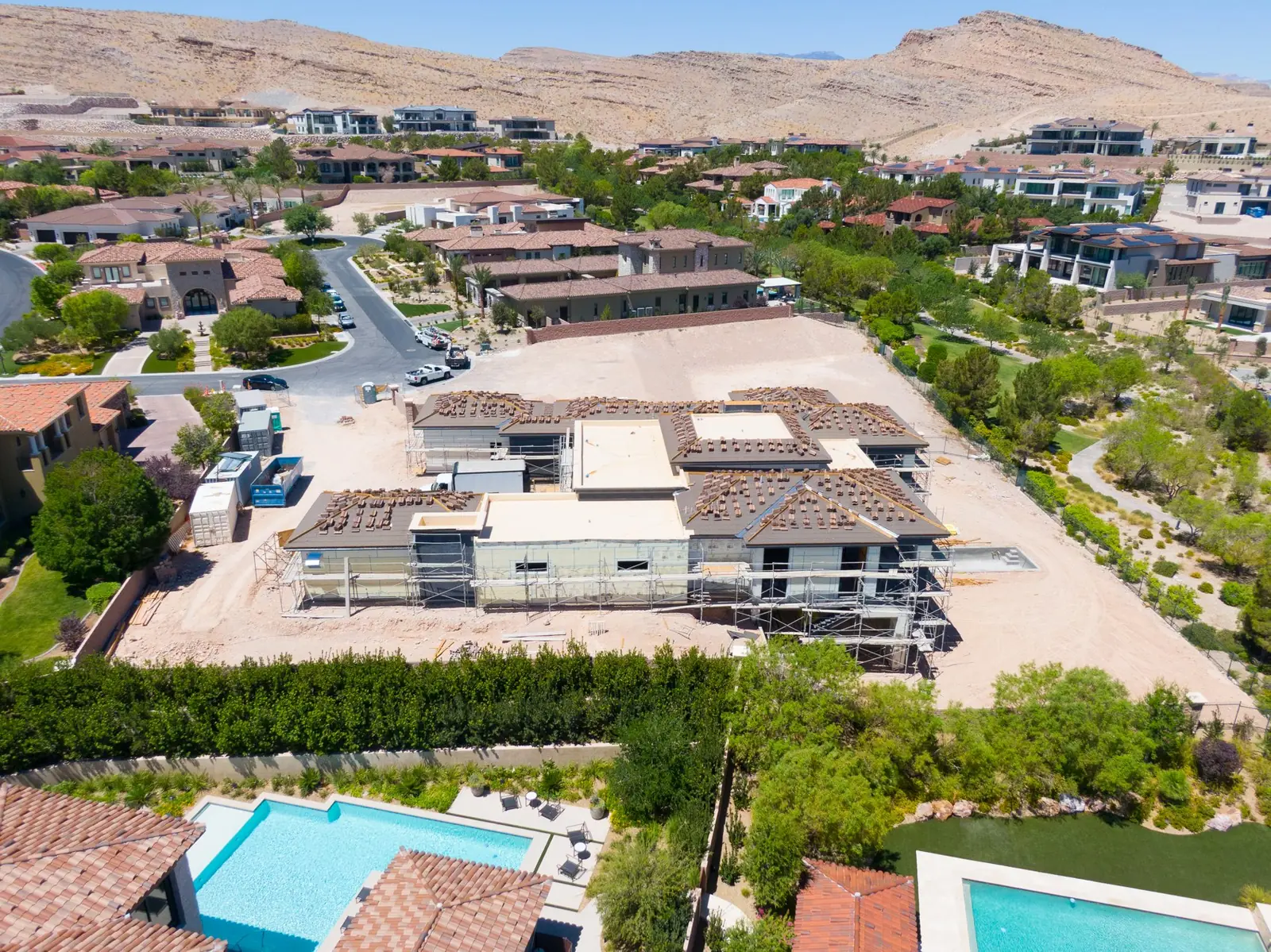 Aerial looking across the community toward the ridge with the house in the foreground