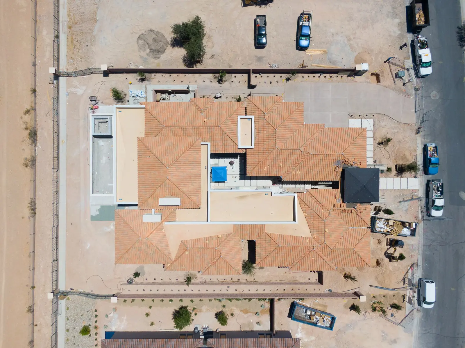 Overhead aerial of 15 Olympia Canyon Way showing the roof, courtyard, pool and motor court