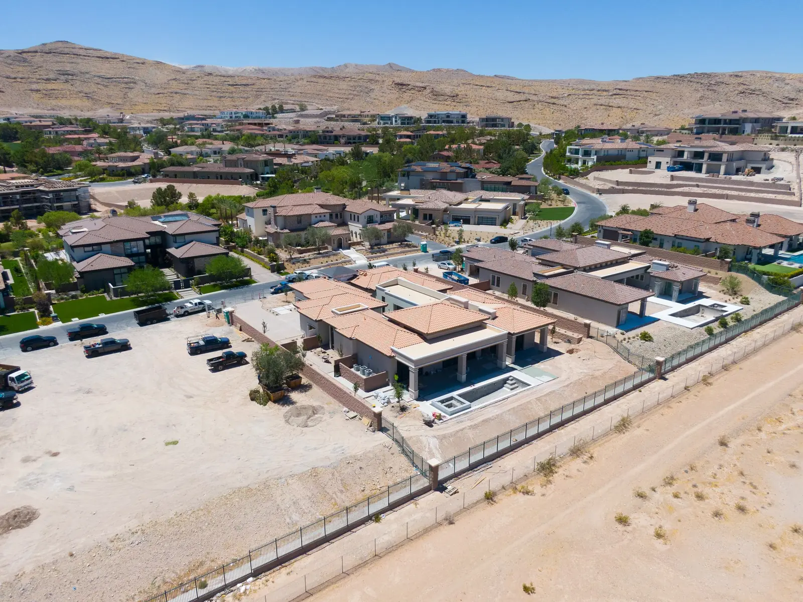 Aerial of the rear yard and pool with the boundary fence and open ground beyond