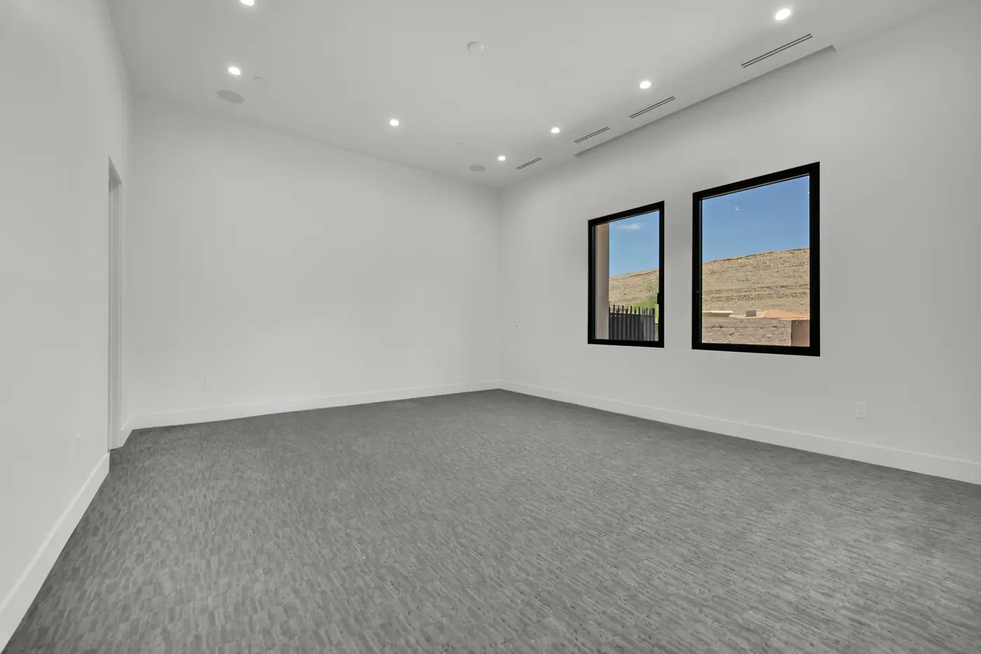 Bedroom with carpet and a window onto the hills