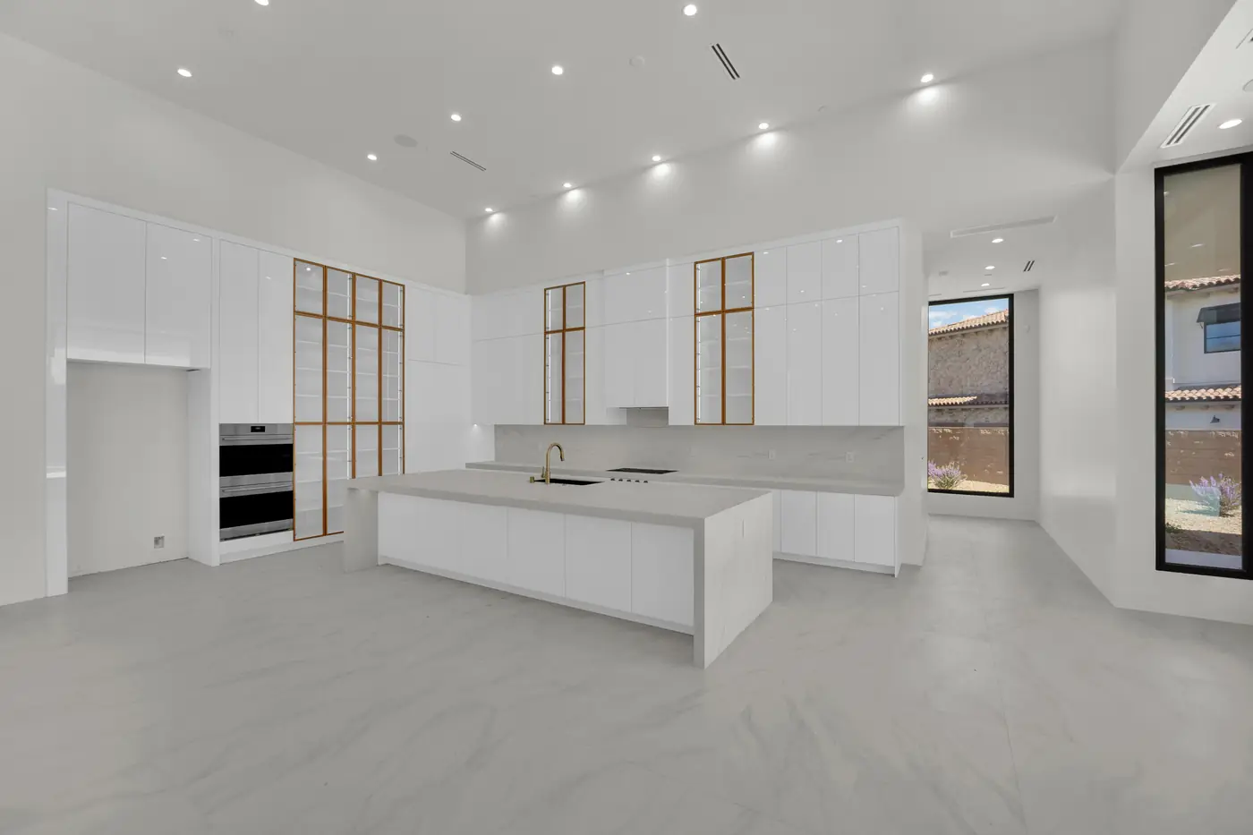 Kitchen from the great room side showing the island and the window wall