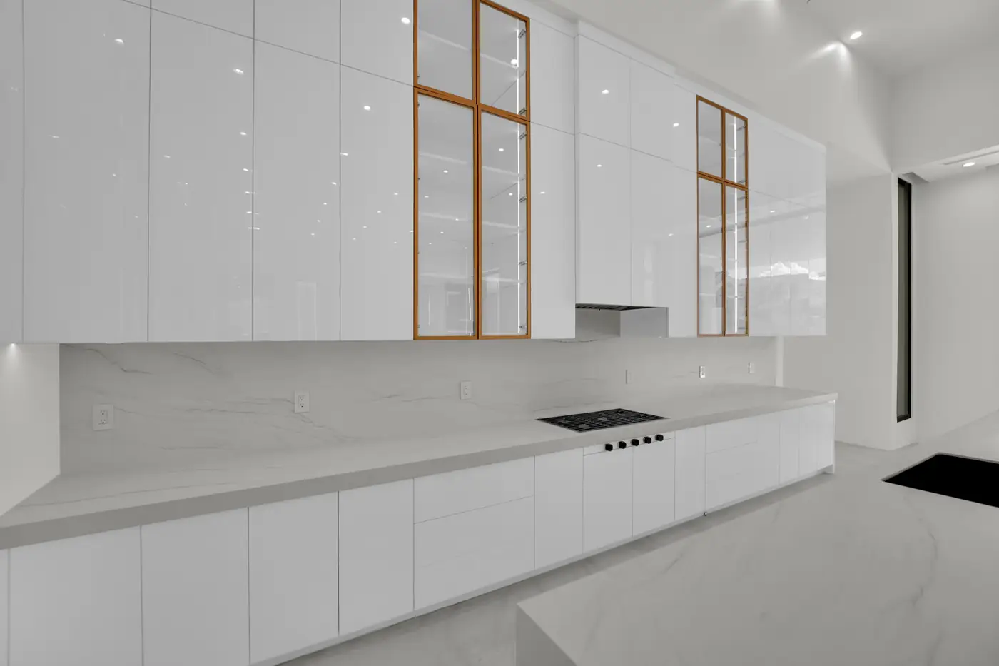 Kitchen cooktop run with the counter and cabinetry above