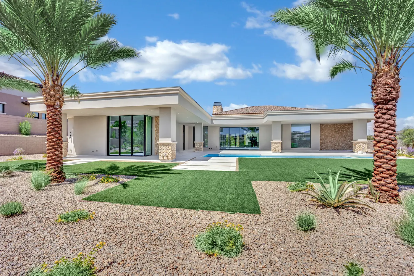 Rear yard with palms, turf and the perimeter wall