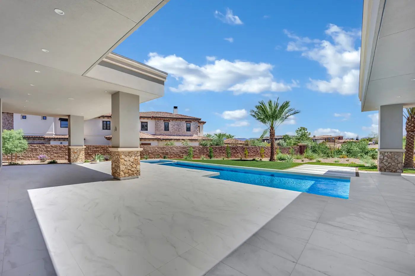 Patio and pool with the neighbouring roofs beyond the wall