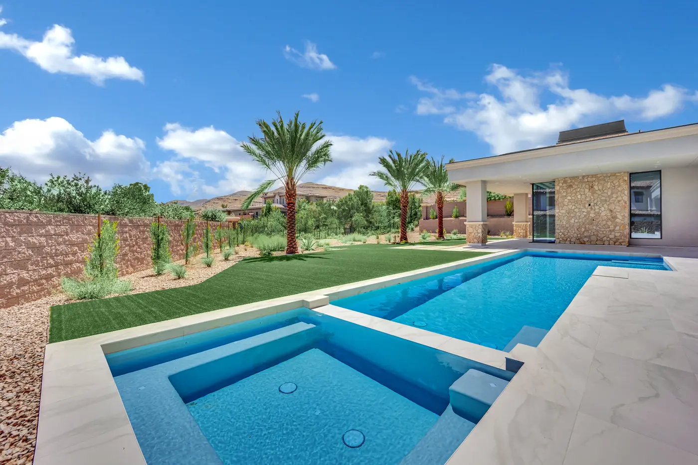 Pool and palms with the ridge rising behind the community