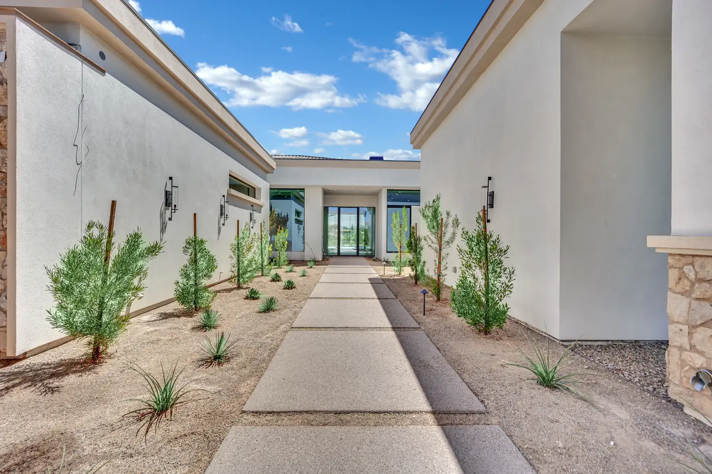 The entry courtyard looking along the walk to the front door