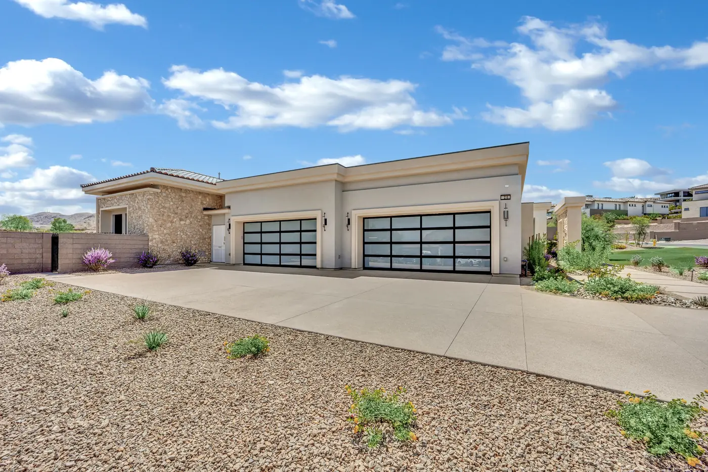 Glass garage doors on the motor court seen from the driveway