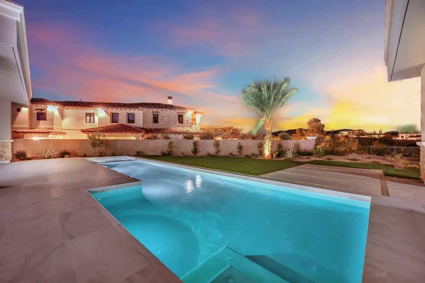 The pool at dusk with the neighbouring rooflines behind