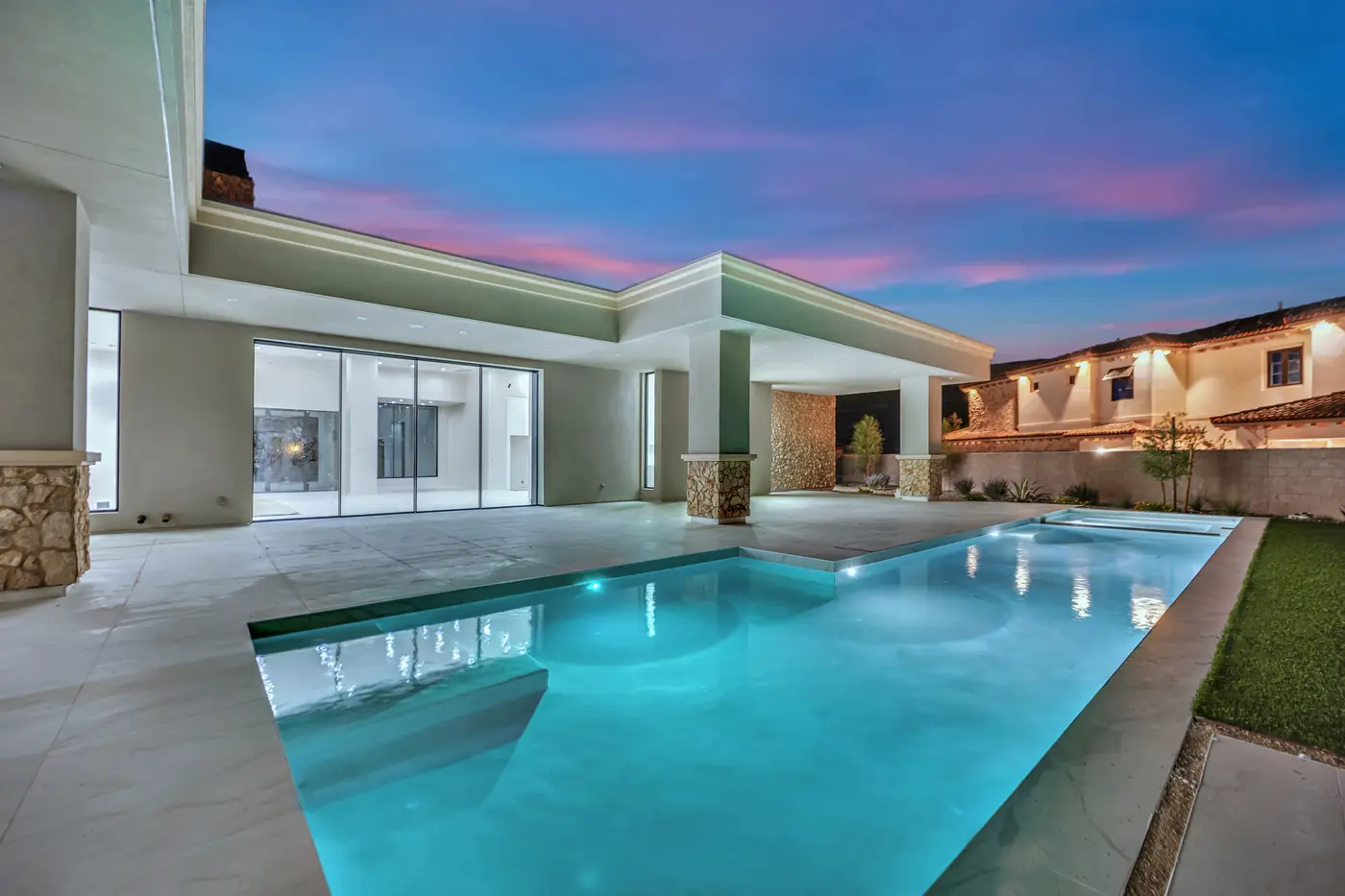 Covered patio and pool at dusk from under the roof