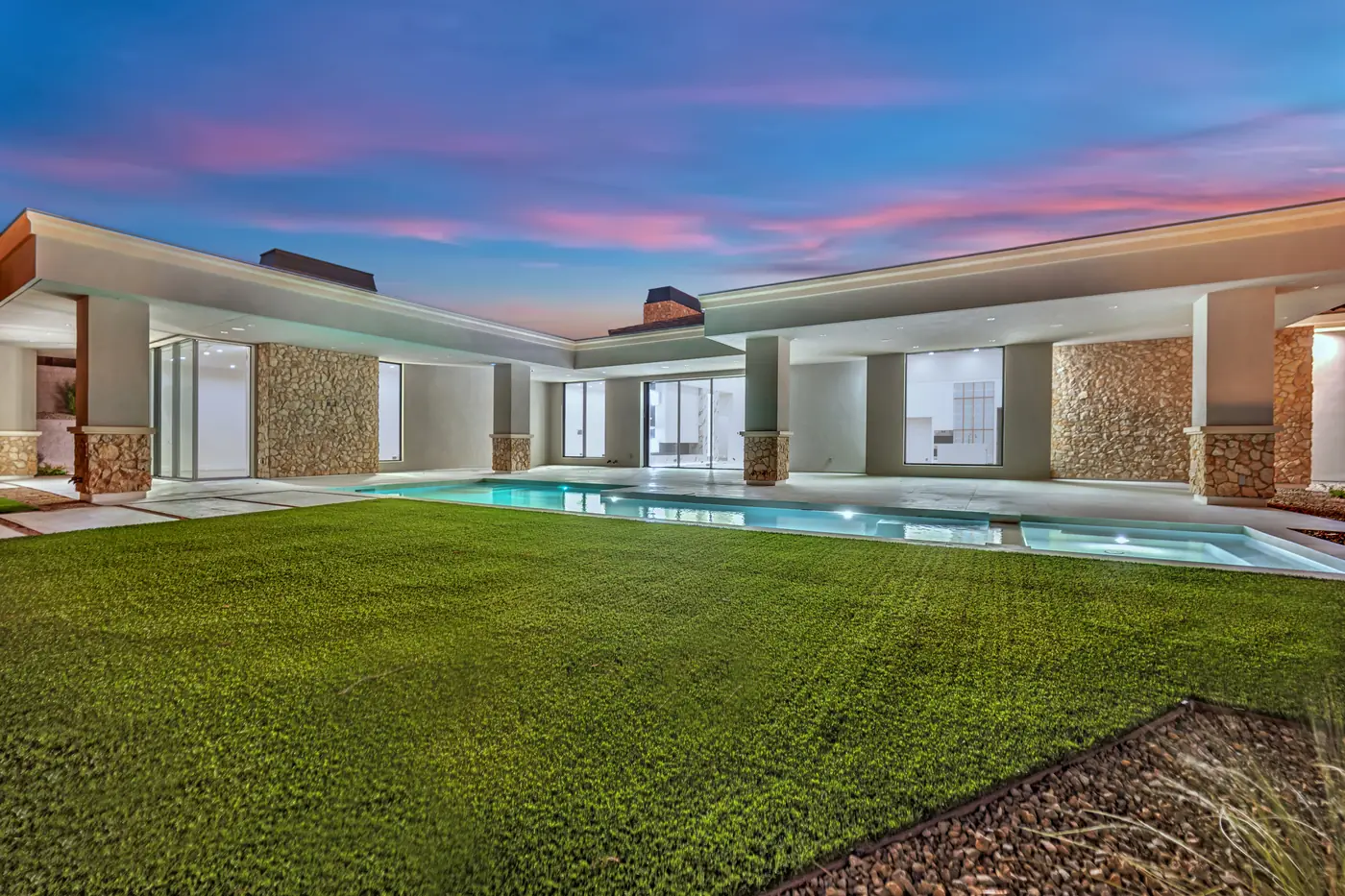 Rear of the house at dusk across the lawn